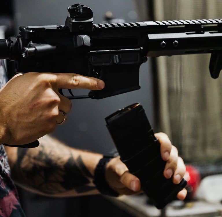 A Person Reloading a Rifle shtf plan